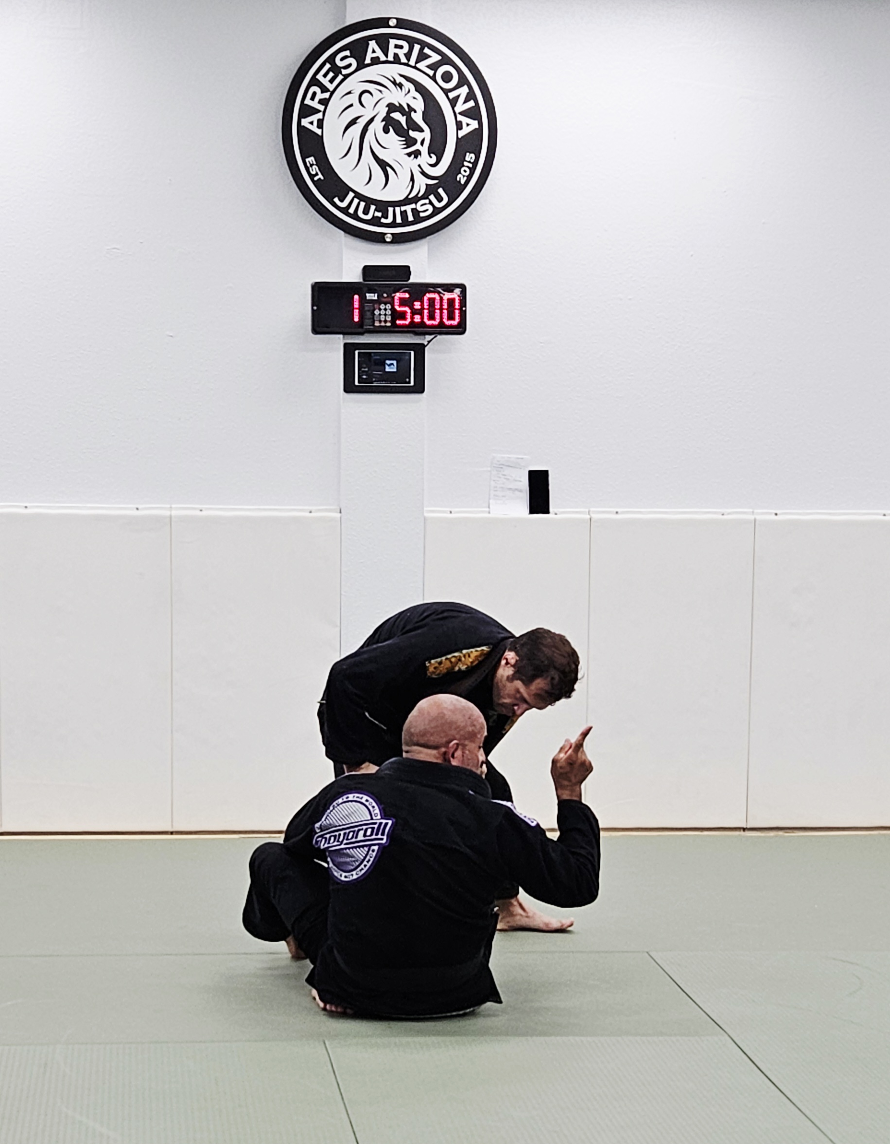 Training session under Ares Arizona BJJ logo
